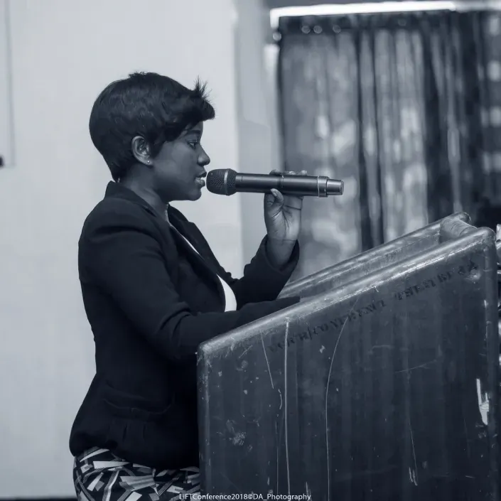 Grace speaking at a conference